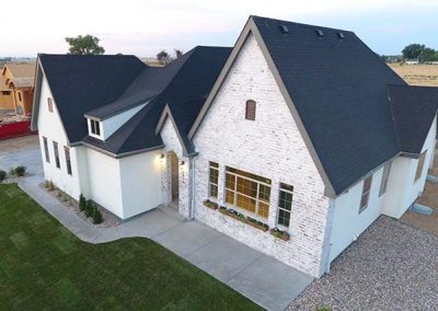 Modern white brick house with dark roof