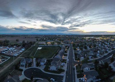 Aerial view of suburban neighborhood at dusk.