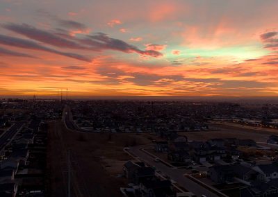 Aerial view of suburb at sunset.