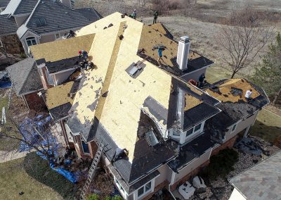 Workers repairing a residential roof