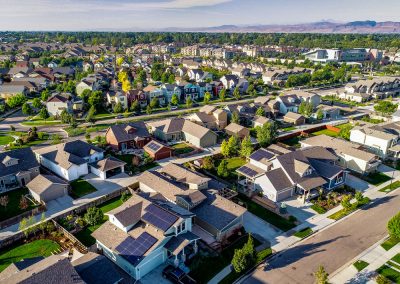 Aerial view of suburban neighborhood with houses and trees.